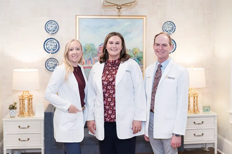 Photo of Doctors Wright, Duncan, and Robbins standing together in the office.